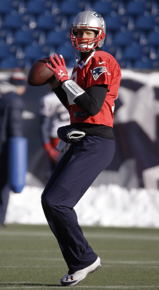 New England Patriots quarterback Tom Brady (12) sets up to throw a pass during a stretching and drills session before practice begins at the NFL football team's facility in Foxborough, Mass., Wednesday, Dec. 18, 2013. The Patriots play the Baltimore Ravens Sunday in Maryland. (AP Photo/Stephan Savoia)