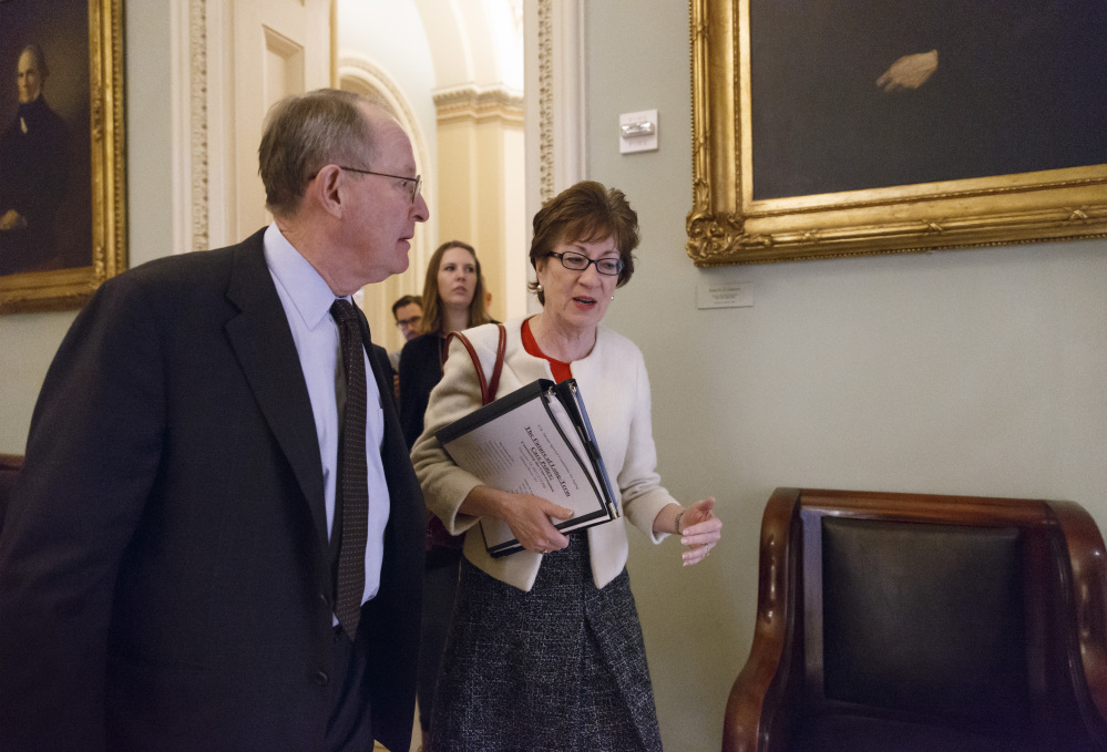 Sen. Lamar Alexander, R-Tenn., left, and Sen. Susan Collins, R-Maine, walk to a closed-door Republican meeting before the Senate moves to pass a modest, bipartisan budget bill, at the Capitol in Washington, Wednesday.