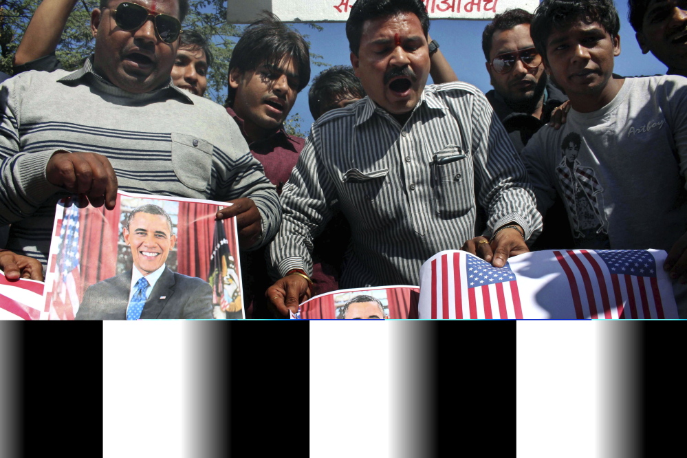 Activists of Sanskriti Bachao Manch, or save culture forum, burn posters of U.S. President Barack Obama and U.S. flags during a demonstration in Bhopal, India, Wednesday, to protest against the alleged mistreatment of New York-based diplomat Devyani Khobragade.