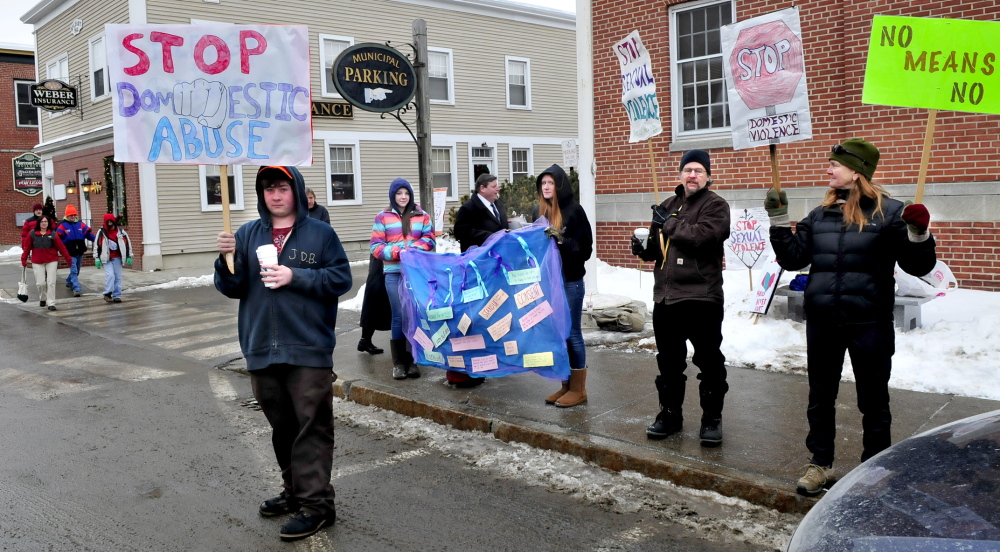 silent AND CLEAR: Mt. Blue High School students and staff demonstrate silently against sexual violence by holding signs and distributing information on Main Street in Farmington on Thursday. From left are Jonah Bragg, Cassie Ross, Tashia Berkey and teacher John Schoen and his wife, Patty.