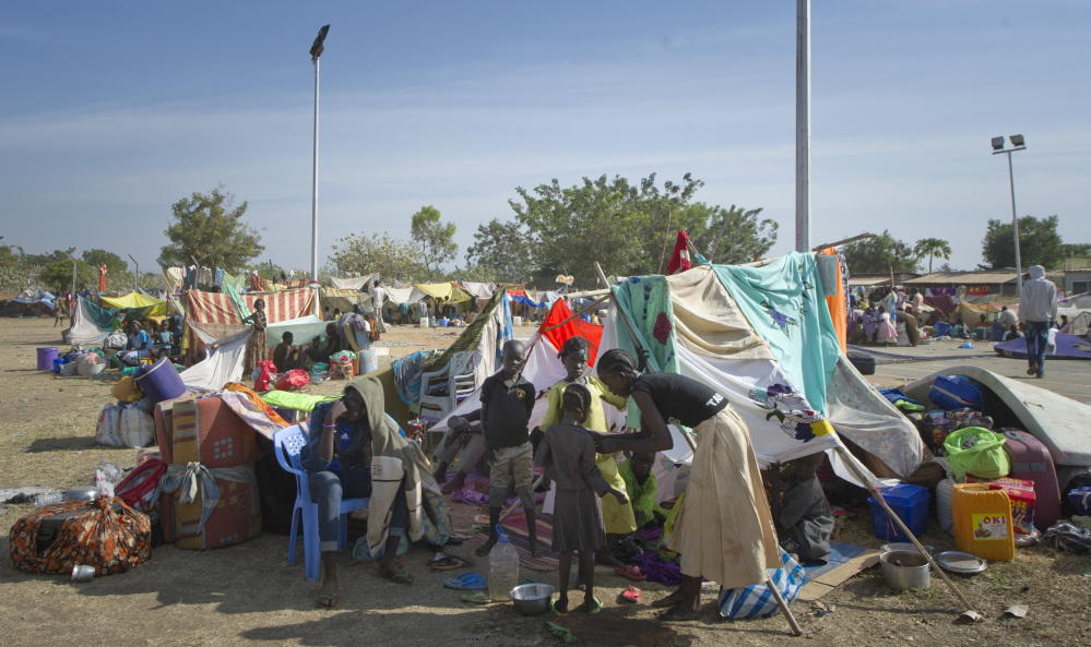A displaced family sits with their belongings after seeking refuge at a U.N. compound in Juba, South Sudan, Thursday. The world’s newest country, is threatened by rapidly escalating ethnic violence, as officials said Thursday that the government no longer controls the capital of its largest and most populous state.