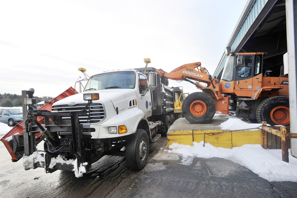 Portland Public Works employees load salt and sand trucks Thursday in preparation for expected precipitation this weekend.