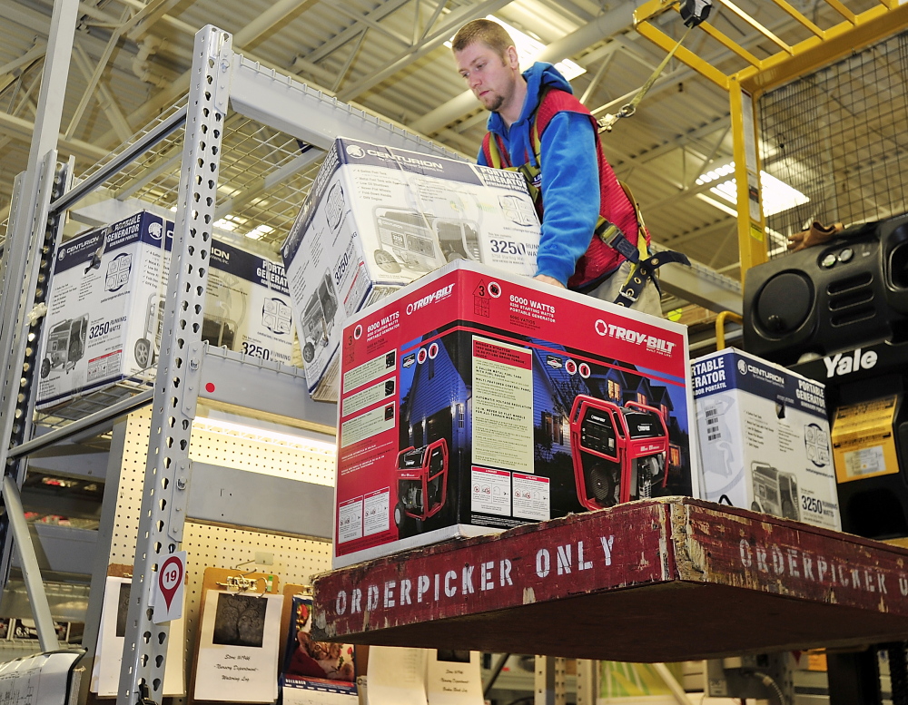 John Owen pulls down generators at Lowes in Portland on Friday in preparation for customers’ needs this weekend if an ice storm causes electrical outages. Gordon Chibroski, Staff Photographer