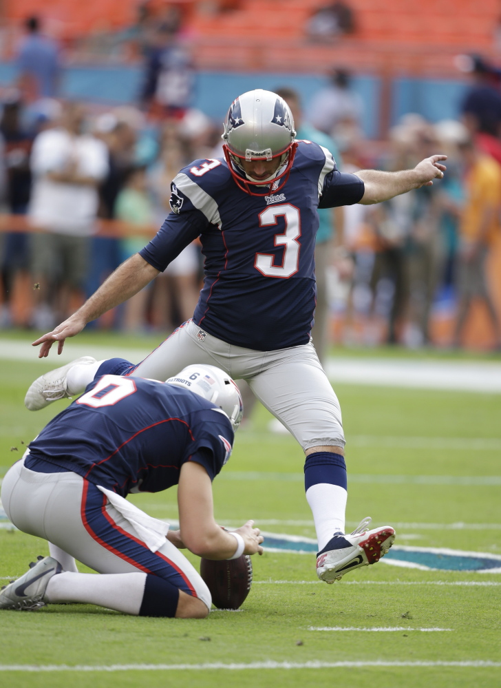 New England Patriots kicker Stephen Gostkowski (3) kicks the ball during practice as punter Ryan Allen (6) holds during practice before an NFL football game against the Miami Dolphins, Sunday, Dec. 15, 2013, in Miami Gardens, Fla. (AP Photo/Lynne Sladky)