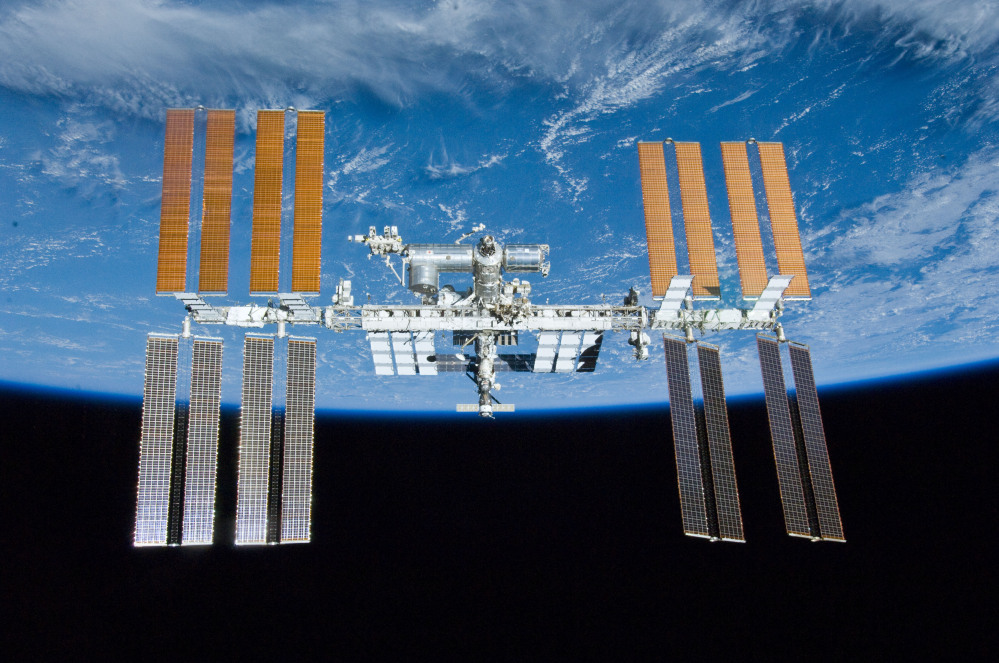 The International Space Station with the Earth in the background. NASA decided to schedule a series of urgent spacewalks to fix a broken cooling line at the International Space Station.