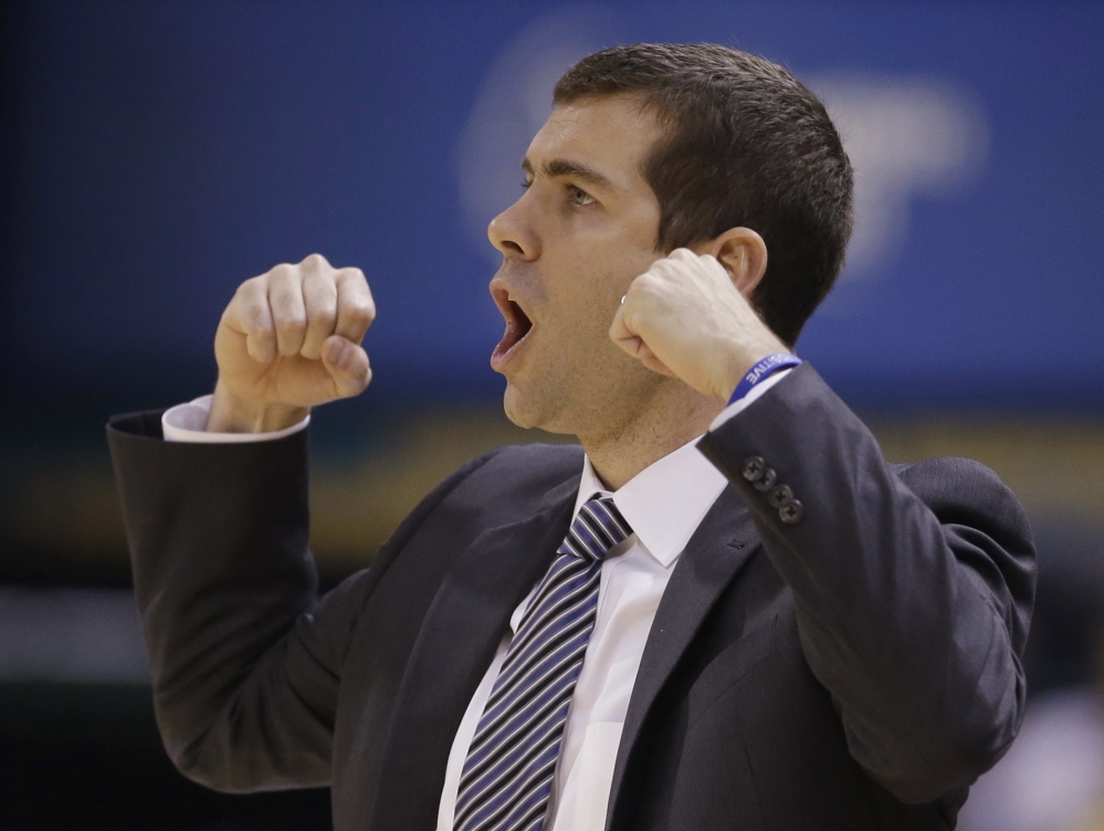 Boston Celtics coach Brad Stevens calls a play during the first half of the Celtics' NBA basketball game against the Indiana Pacers on Sunday, Dec. 22, 2013, in Indianapolis. (AP Photo/Darron Cummings)