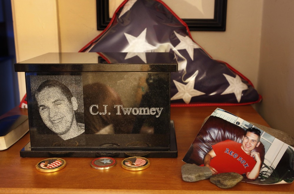 An urn containing the ashes of C.J. Twomey is surrounded by mementos at his parents’ home in Auburn.