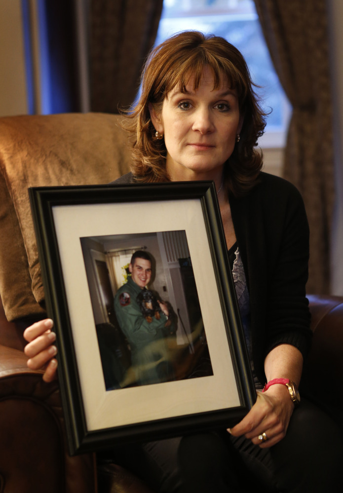 Hallie Twomey shows a photo of her son, C.J., at her home in Auburn. C.J. committed suicide three and a half years ago. Twomey is asking people to help scatter his ashes throughout the world so he can become part of the world he never got to see.