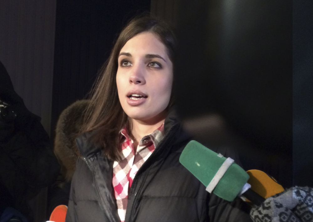 Nadezhda Tolokonnikova speaks to the media after leaving prison in Krasnoyarsk, Russia, on Monday. The member of the Russian punk bank Pussy Riot has been released from custody following an amnesty law passed by parliament. Tolokonnikova left the prison colony in the eastern Siberian city of Krasnoyarsk on Monday, hours after another band member, Maria Alekhina, was released in another region.