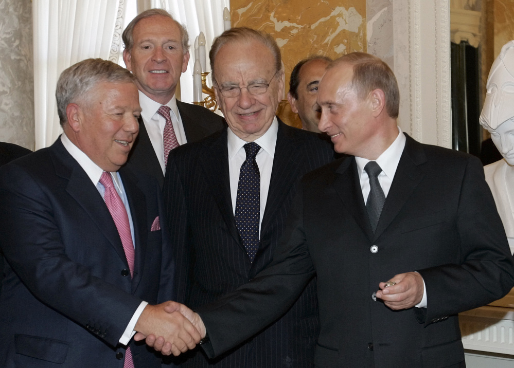 THAT’S MY RING: Russian President Vladimir Putin, right, shakes hands with New England Patriots owner Robert Kraft while holding Kraft’s diamond-encrusted 2005 Super Bowl ring, as News Corp. Chairman Rupert Murdoch, center, looks on during a meeting of American business executives at the 18th century Konstantin Palace outside St. Petersburg, Russia in this June 25, 2005 photo. The mystery of Robert Kraft’s wayward Super Bowl ring was one of many odd places sports wandered into in 2013.