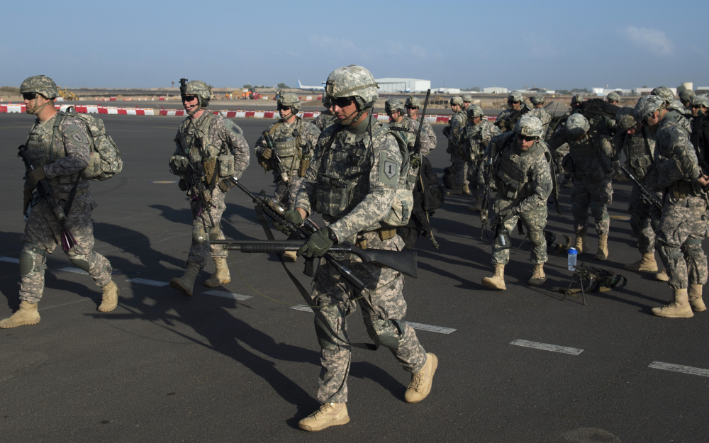 U.S. Army soldiers of the East Africa Response Force (EARF), a Djibouti-based joint team assigned to Combined Joint Task Force-Horn of Africa, prepare to load onto a U.S. Air Force C-130 Hercules at Camp Lemonnier, Djibouti.