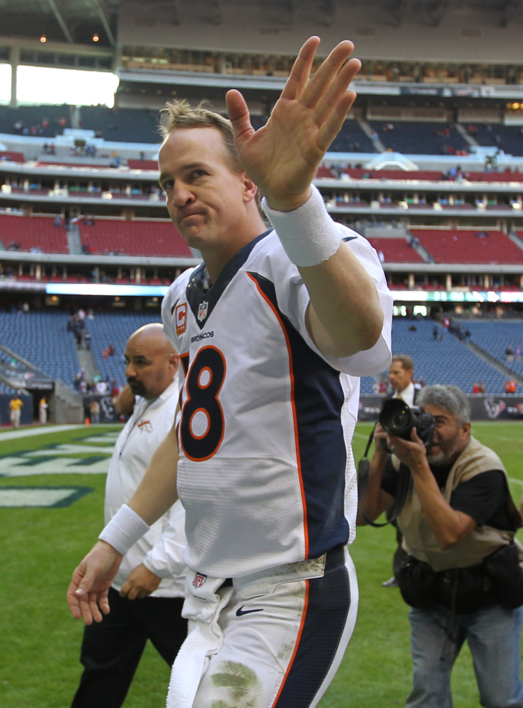 RECORD BREAKER: Denver Broncos quarterback Peyton Manning waves to the crowd after breaking the single-season touchdown Sunday the Houston Texans in Houston.