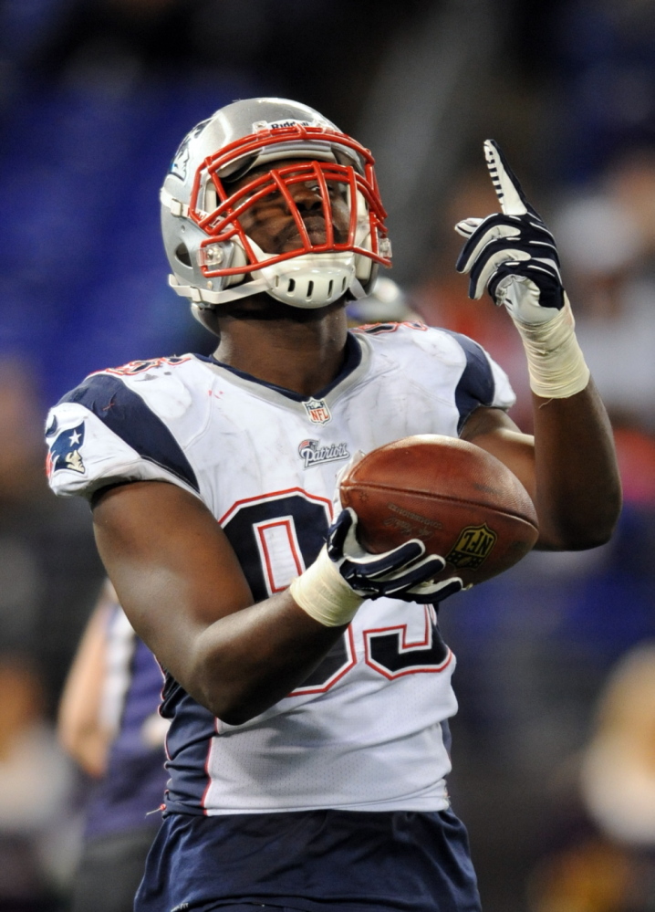 BIG PLAY: New England defensive end Chandler Jones celebrates after scoring a touchdown after he recovered a fumble in the second half of the Patriots’ 41-7 win over the Baltiomore Ravens on Sunday in Baltimore.