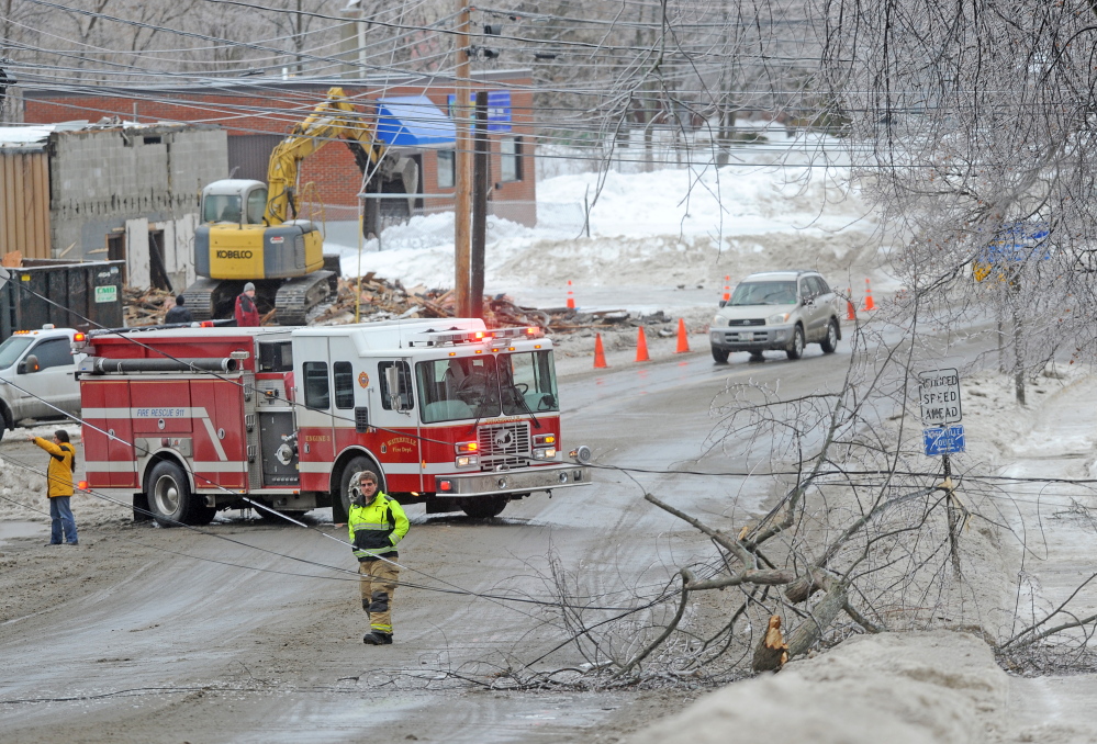 LINES DOWN: The Waterville Fire Department closed down a section of Main Street in downtown Waterville Monday afternoon after a branch broke under the strain of heavy ice.
