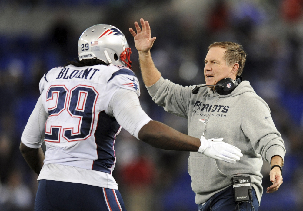 New England Patriots head coach Bill Belichick, right, celebrates with running back LeGarrette Blount after Blount scored a touchdown in the second half of Sunday’s game against the Baltimore Ravens.