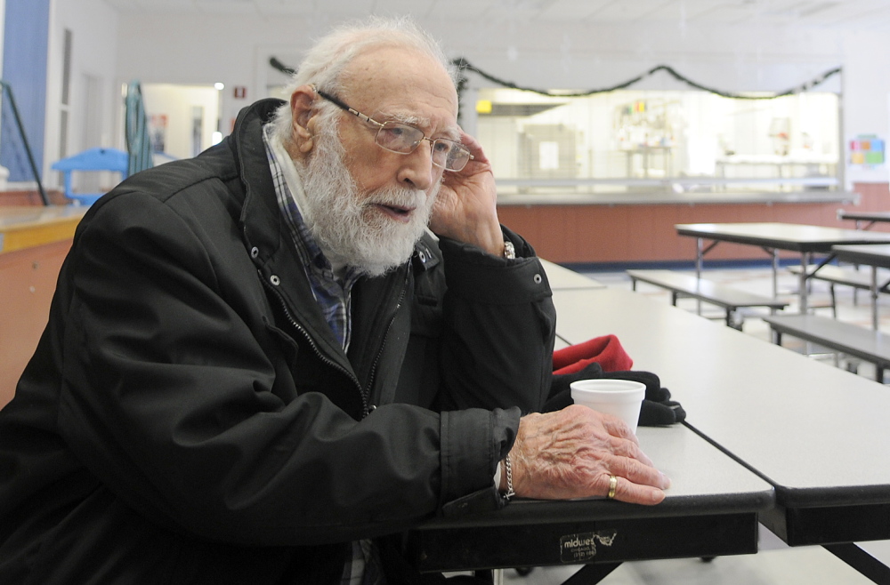 Staff photo by Andy Molloy SHELTER: Nunzio Biondello sips coffee Tuesday at the Carrie Ricker School in Litchfield, which opened as a shelter for residents of the down. The 89-year-old had been without either power or heat for a day.