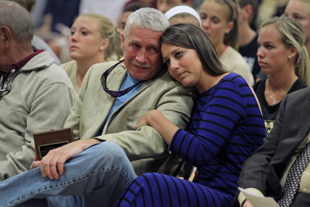 Kayleigh Ballantyne, right, of Gorham, hugs her father, Bruce, during the Opening Convocation at Bryant University in Rhode Island on Sept. 4. Kayleigh received the university’s Character Award for her courage in confronting her assailant.