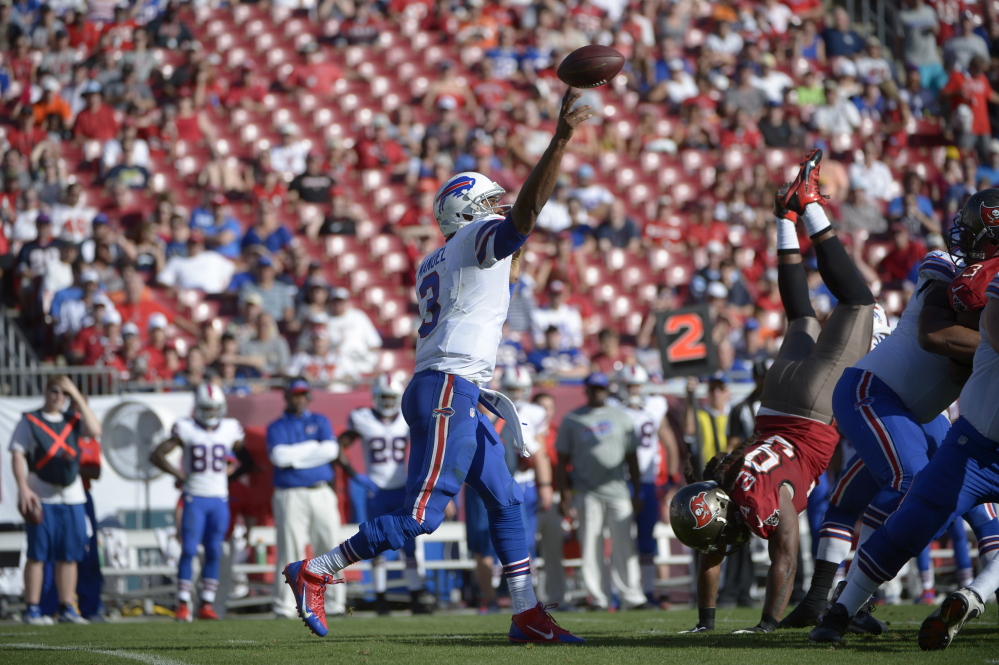 Buffalo Bills quarterback EJ Manuel (3) throws a pass in front of Tampa Bay Buccaneers defensive end Adrian Clayborn (94) during the second half of an NFL football game in Tampa, Fla., Sunday, Dec. 8, 2013.(AP Photo/Phelan M. Ebenhack)