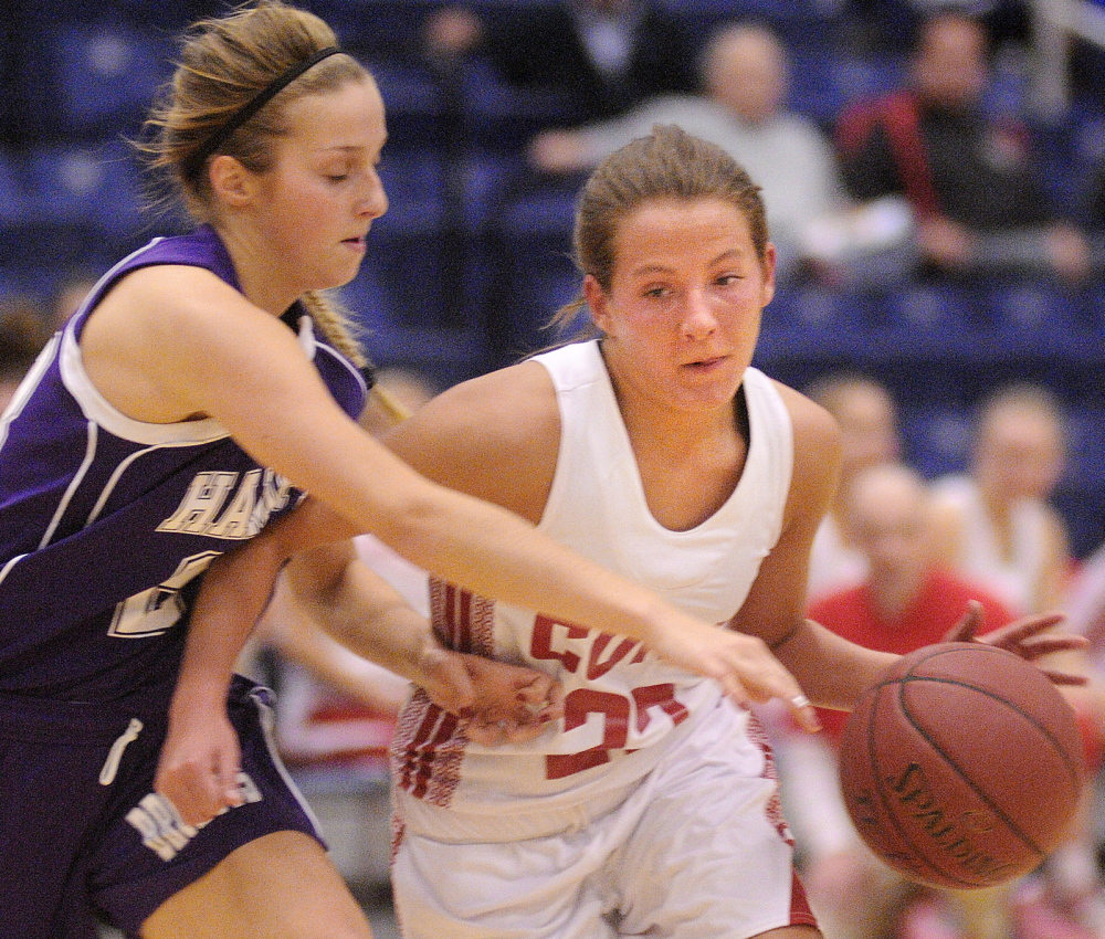 Staff photo by Andy Molloy MOVE OVER: Cony High School's Hayley Quirion, right, dribbles past Hampden Academy's Elise Arsenault Friday during a basketball match up in Augusta during the Capital City Hoop Classic.