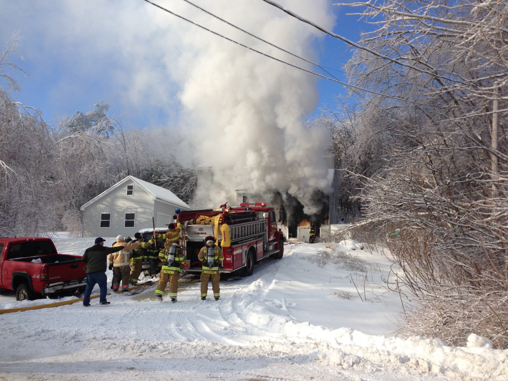 FIRE RESPONSE: Crews respond to a fire at Fire Road 14 in China Friday morning. Homeowner Neil Farrington saved his disabled brother-in-law from the blaze, but the home was a loss.