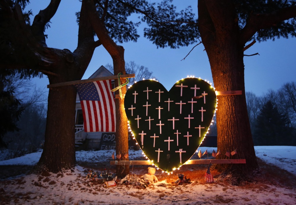 A makeshift memorial with crosses for the victims of the Sandy Hook massacre stands outside a home in Newtown, Conn., earlier this month on the one-year anniversary of the shootings. Connecticut authorities Friday released state police documents from the investigation.