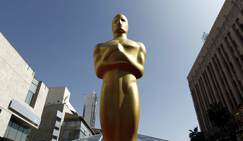 FILE - A Oscar statue is seen on the red carpet before the 84th Academy Awards in Los Angeles. Voting begins Friday, Dec. 27, 2013, for 2014ís Academy Awards nominees. Members of the Academy of Motion Picture Arts and Sciences are invited to cast secret ballots for their favorite film work from the past year until Jan. 8, 2014.