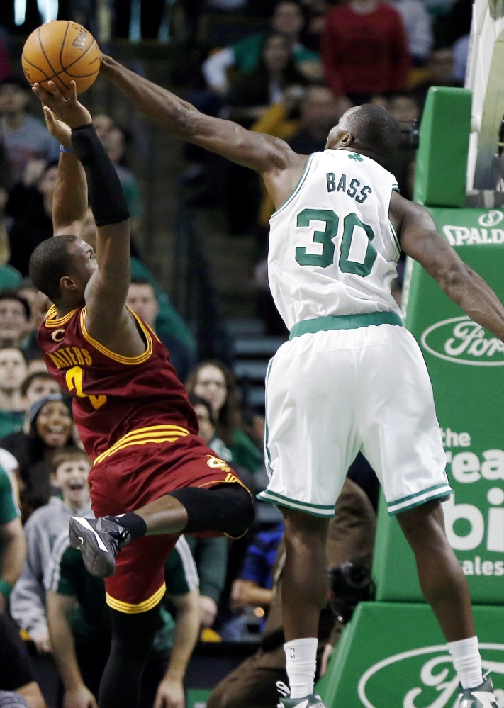 Boston Celtics' Brandon Bass (30) blocks a shot by Cleveland Cavaliers' Dion Waiters (3) with seconds left on the clock in the third quarter of an NBA basketball game in Boston, Saturday, Dec. 28, 2013. The Celtics won 103-100. (AP Photo/Michael Dwyer)