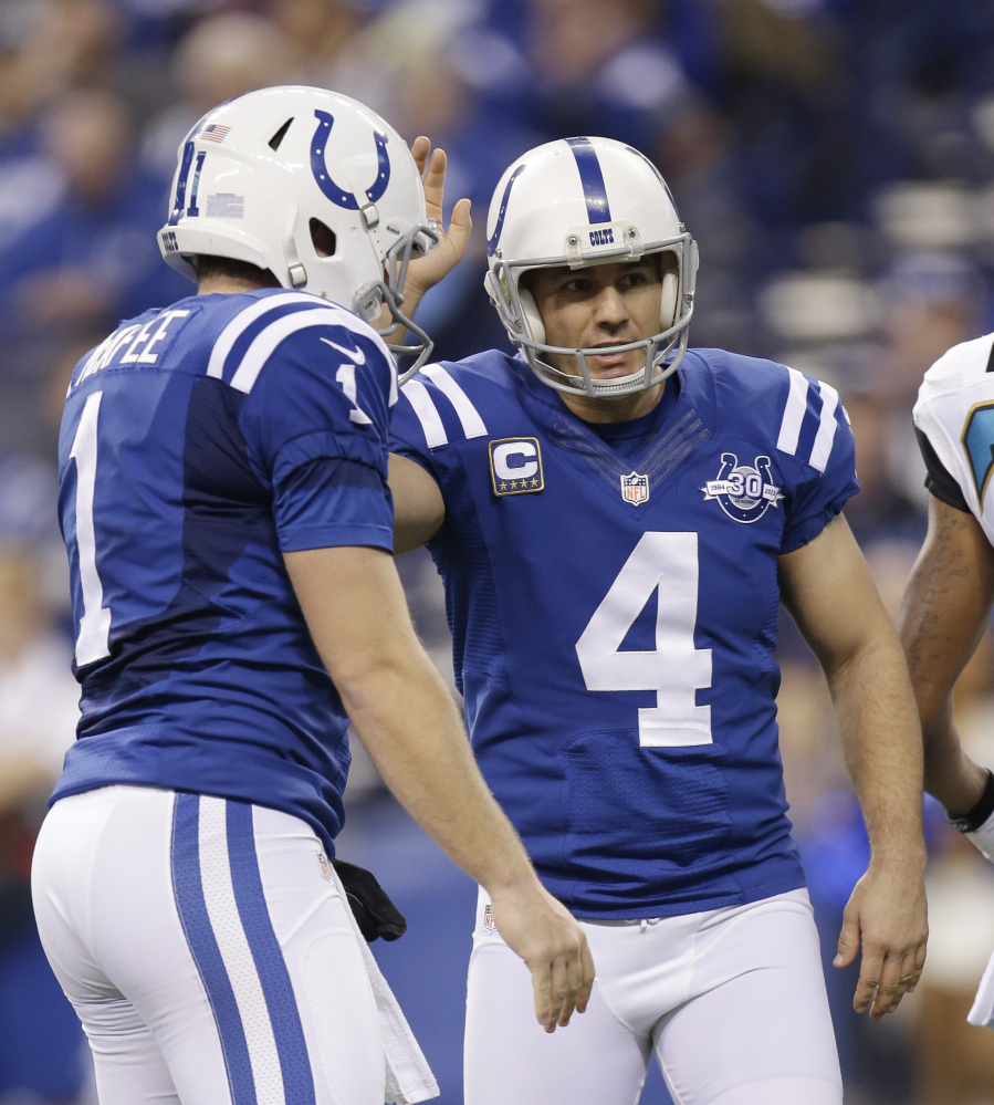 Indianapolis Colts' Adam Vinatieri (4) is congratulated by Pat McAfee (1) after kicking a 23-yard field goal during the first half of an NFL football game against the Jacksonville Jaguars, Sunday, Dec. 29, 2013, in Indianapolis. (AP Photo/AJ Mast)
