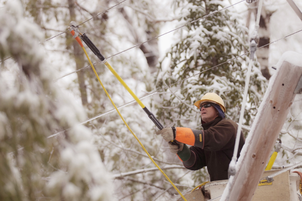 Maine Public Service lineman Craig Hobbs works to restore power in Orrington on Sunday.