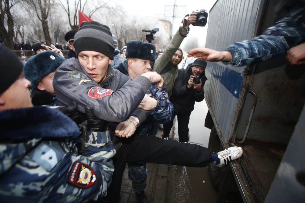 Police officers detain people who gathered for an unsanctioned event in downtown Volgograd, Russia, on Monday. Volgograd is about 400 miles northeast of Sochi, where the Olympics are to be held.