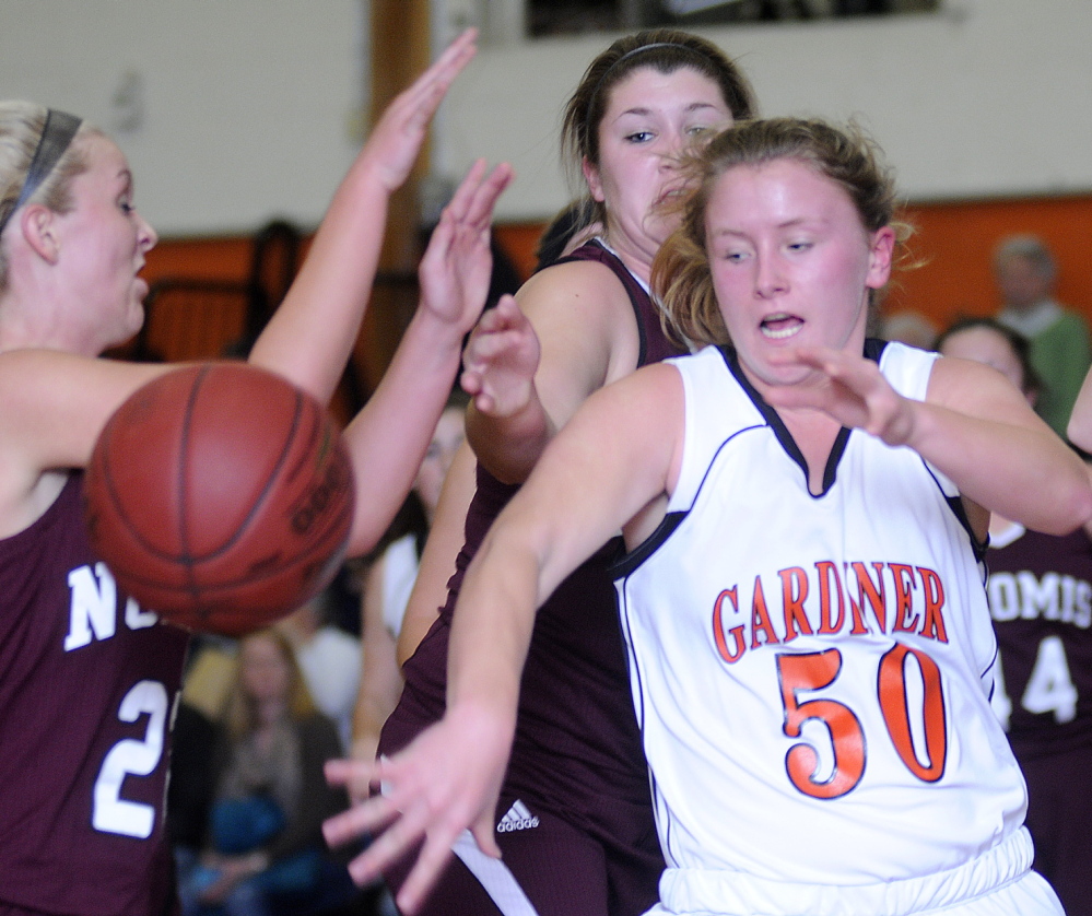 Staff photo by Andy Molloy Gardiner Area High School's Camden Cone, right, chases a rebound through a wall of Nokomis High School defenders during a basketball match Monday in Gardiner.