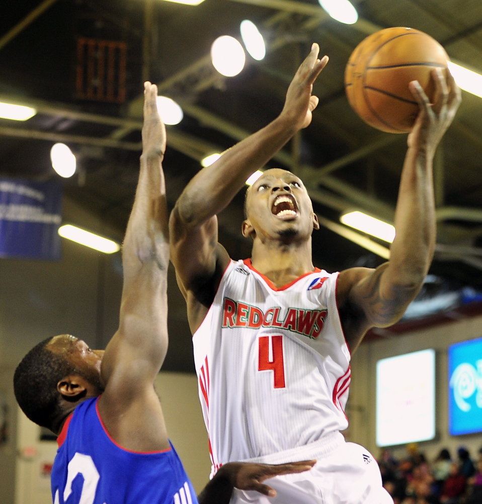 Red Claws Frank Gaines takes it up for two over Delaware’s Mfon Udofia at the Portland Expo on Tuesday.
