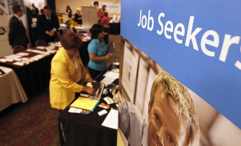 In this Tuesday, July 2012 file photo, people mingle with recruiters at a jobs fair. As many as 3,300 Mainers could lose a key source of income – if not their only source – during the holidays because Congress has not extended a long-term unemployment program.