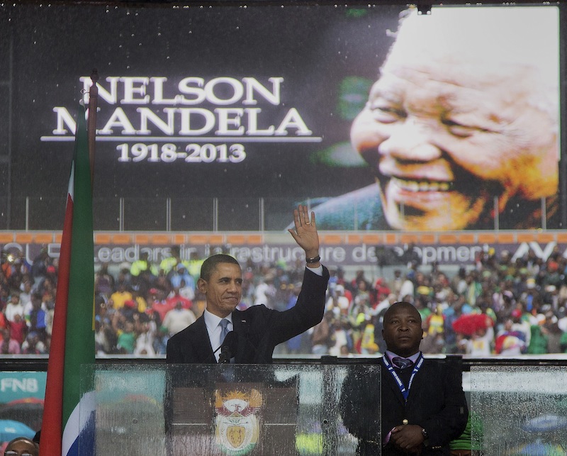 President Barack Obama waves as he arrives to speak at the memorial service for former South African president Nelson Mandela at the FNB Stadium in the Johannesburg, South Africa township of Soweto, Tuesday, Dec. 10, 2013. World leaders, celebrities, and citizens from all walks of life gathered on Tuesday to pay respects during a memorial service for the former South African president and anti-apartheid icon.