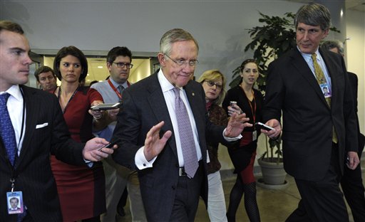 Reporters pursue Senate Majority Leader Harry Reid of Nevada, center, on Capitol Hill Wednesday.
