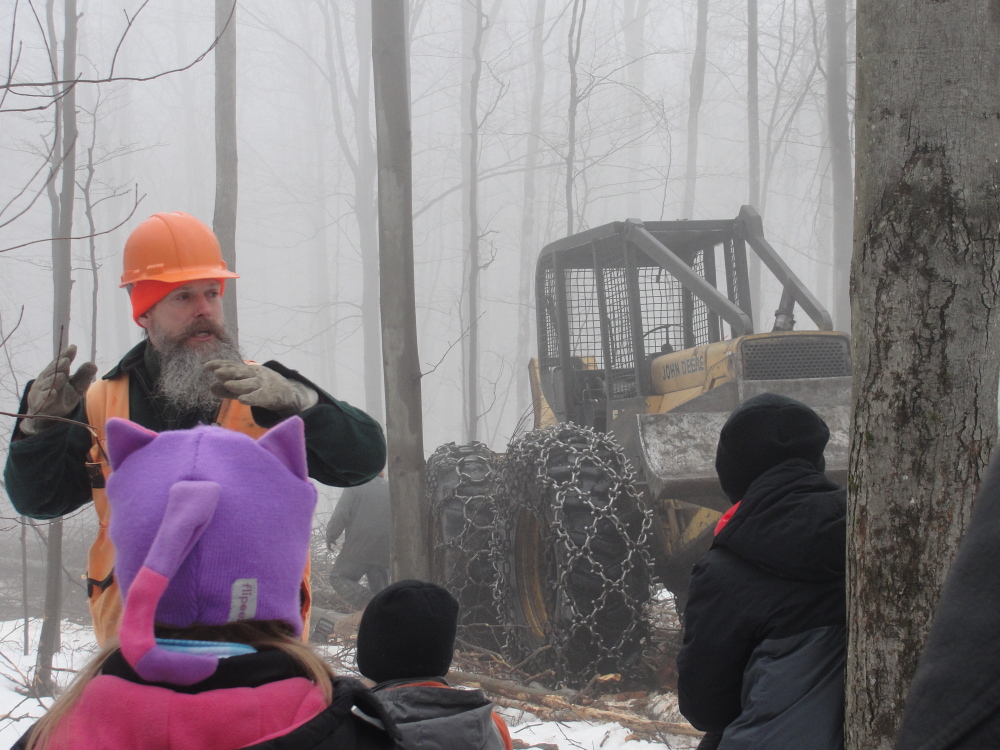 Morton Moesswilde, a district forester with the Maine Forest Service, instructs fourth-grade students from Regional School Unit 4 — Litchfield, Wales and Sabattus — on forestry and logging practices recently in Litchfield. More than 100 students attended the field trip, on Oak Hill Road, where they saw logging and sawmill equipment in action.