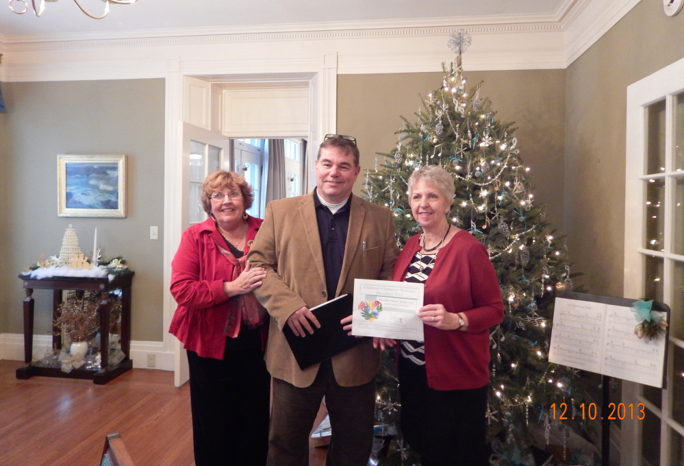 Jeffrey Johnson, executive director of the Children’s Center in Augusta, presents the Garden Therapy Committee of the Kennebec Valley Garden Club with the Children’s Champion Nominee Award for 2013 at a Holiday Tea event held recently at the Blaine House in Augusta. From left is Karen Foster, the club’s president, Johnson, and Nancy Voisine, first vice president and committee chairman. The club’s Garden Therapy Committee has spent time over the past few summers working in the Butterfly Garden and the raised bed Sensory Garden at the Children’s Center as one of their projects.