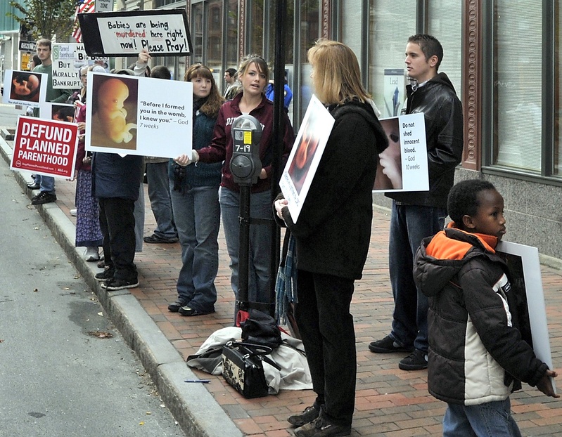 Anti-abortion demonstrators protest with graphic signs outside the Planned Parenthood of New England agency on Congress Street in Portland last year. The U.S. Supreme Court is hearing a challenge to a Massachusetts law similar to a Portland ordinance that restricts protests outside abortion clinics within a 39-foot buffer zone.