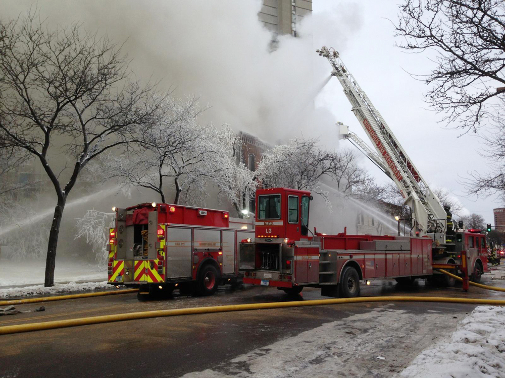 Firefighters work the scene where a fire engulfed several apartment units in the Cedar Riverside neighborhood, in Minneapolis, Wednesday, Jan. 1, 2014. Authorities say at least 13 people have been hurt.