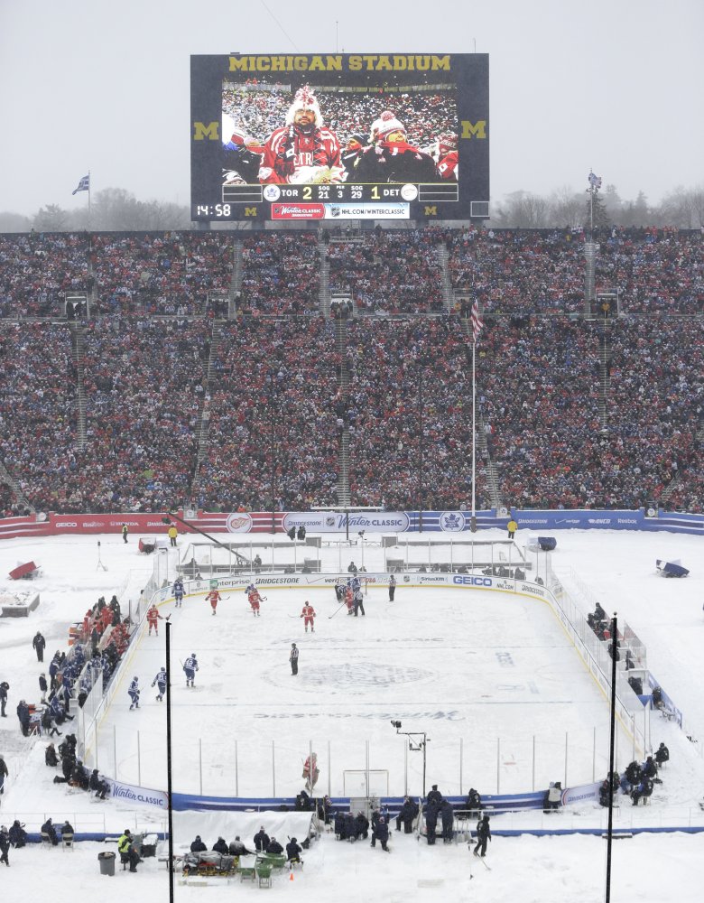 The Detroit Red Wings and the Toronto Maple Leafs skate during the third period of the Winter Classic outdoor NHL hockey game at Michigan Stadium in Ann Arbor, Mich., Wednesday, Jan. 1, 2014. (AP Photo/Carlos Osorio)