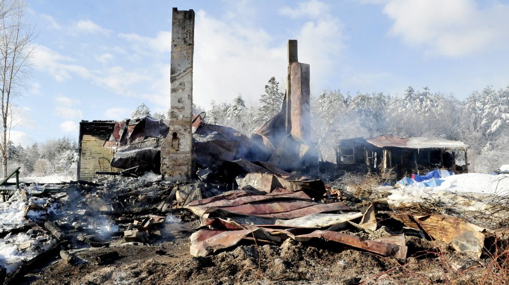 GONE: The remains of this home were still smoldering on Wednesday after fire destroyed the home late Tuesday evening on Hutchins Road in Fairfield, leaving two people homeless. Fire officials think the fire might have started near the chimney and said it is not considered suspicious.