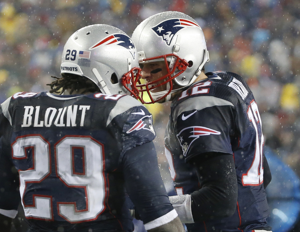 New England Patriots running back LeGarrette Blount (29) celebrates his touchdown with quarterback Tom Brady, right, in the second quarter of an NFL football game against the Buffalo Bills, Sunday, Dec. 29, 2013, in Foxborough, Mass. (AP Photo/Elise Amendola)