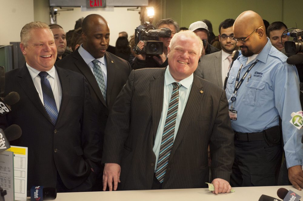 Toronto Mayor Rob Ford registers as a candidate Thursday for the city’s 2014 municipal election in October. Councilor Doug Ford, his brother, is at left.