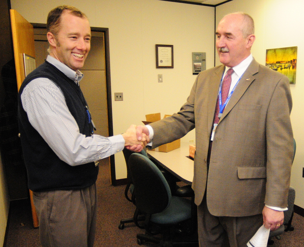 RETIRING: Ryan Lilly, director of the VA Maine Healthcare Systems-Togus, left, congratulates Scott Karczewski, the retiring director of the Togus regional office, on Friday.