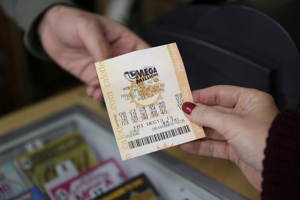A woman purchases a Mega Millions lottery ticket at a San Francisco liquor store on Dec. 12, 2013. Steve Tran purchased his $324 million winning ticket in the Dec. 17 drawing in San Jose.