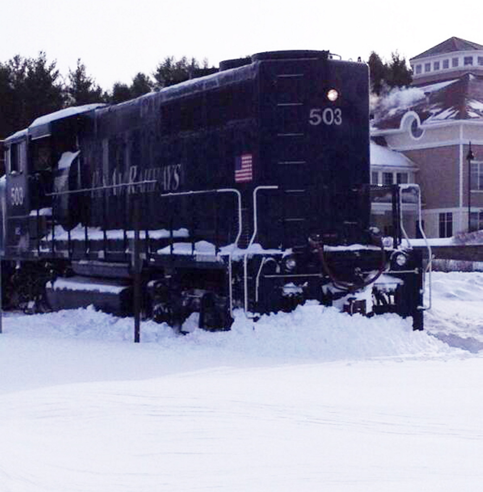 A Pan Am Railways locomotive sits where it slipped off the track near Industrial Park Road in Saco on Friday.
