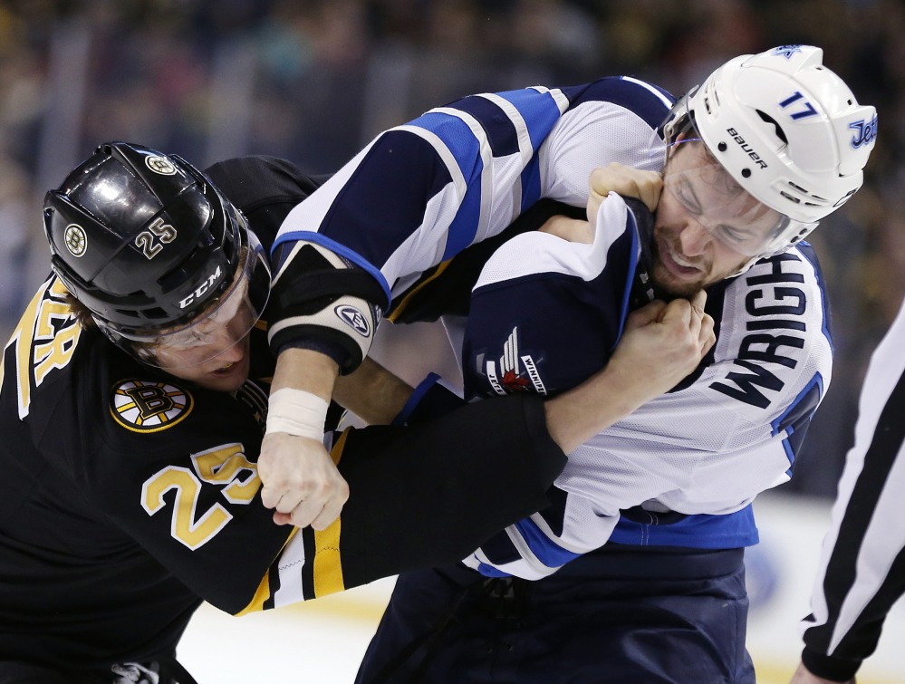 Matt Fraser of the Bruins battles with Winnipeg’s James Wright – one of two fights in the opening four minutes Saturday afternoon. Boston won, 4-1.