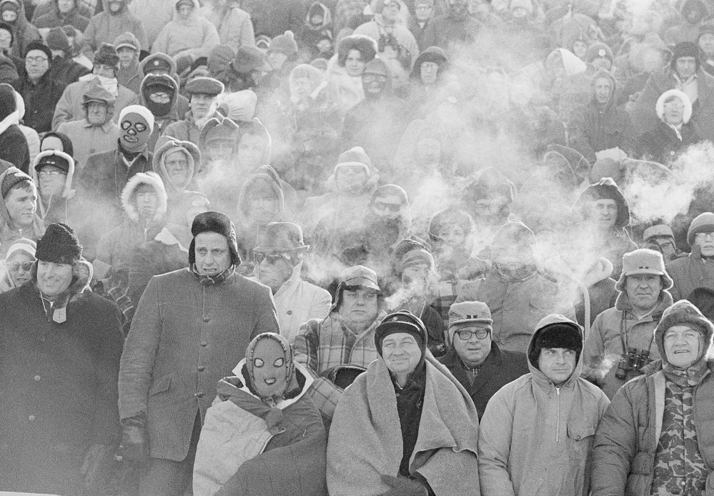 In this Dec. 31, 1967 file photo, fans watch the Green Bay Packers play the Dallas Cowboys in the NFL Championship game in Green Bay, Wisc. Comparisons to the legendary 1967 Ice Bowl are inevitable when the mercury dips below zero at Lambeau Field. But even if temperatures sink to minus-13 Sunday at the 49ers-Packers playoff game, modern technology will ensure fans are warmer than their predecessors.