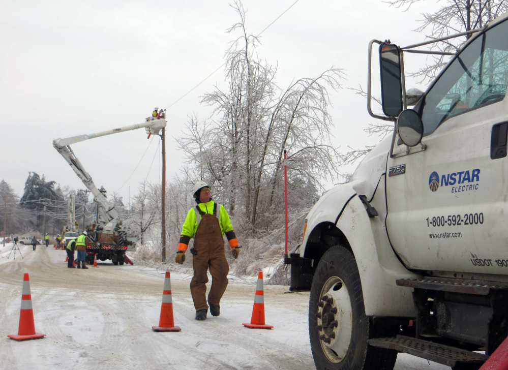 A crew from NSTAR works to restore power in Gardiner on Dec. 26 after the ice storm. Hundreds of utility line crew members and tree trimmers left Maine even as hundreds of customers remained in the dark because Bangor Hydro Electric Co. waved off the extra help.