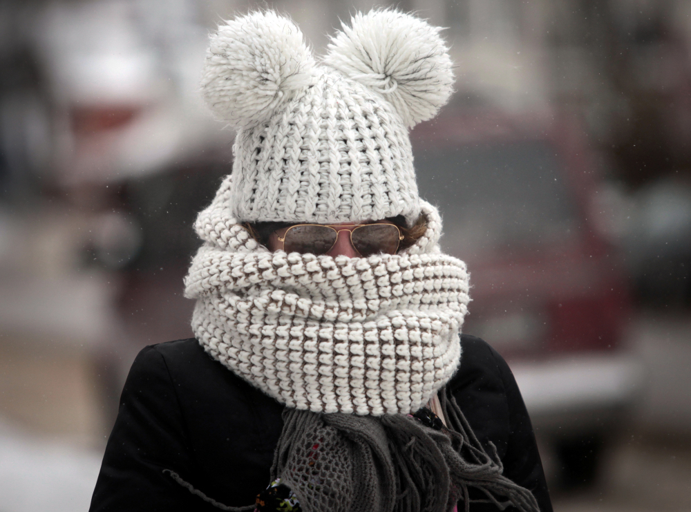 As frigid weather takes hold on the upper Midwest, Kristy Gruley of Madison, Wis., is well-bundled against the elements while walking in the city on Friday.